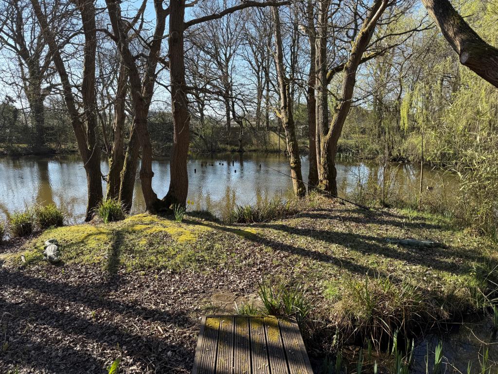 Lot: 80 - FISHING LODGE AND LAKE ON APPROX. ONE ACRE - View of lake from front decking